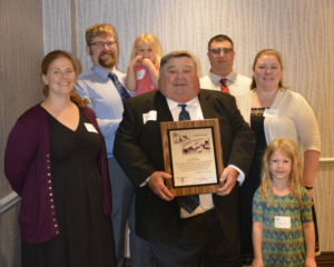  Dave Hahn, Fond du Lac, center, was honored with the prestigious Pioneer Award for his dedicated service to the patron customers of East Central/Select Sires. He is pictured with this family.