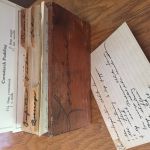 A vintage wooden recipe box with a recipe for cornstarch pudding. 