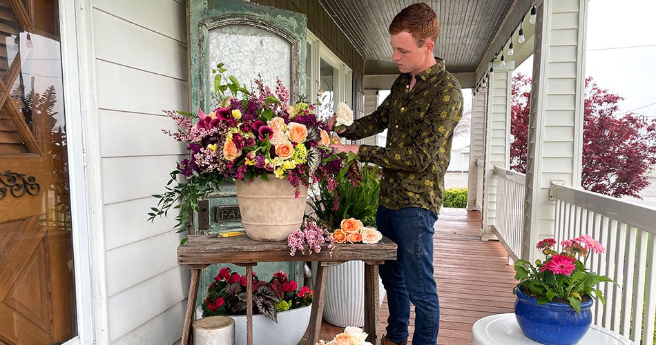 Keaton Topp working on a flower arrangement