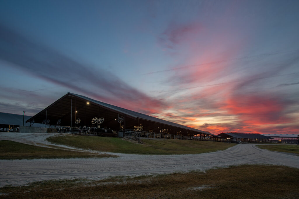 Sunset over a large dairy barn