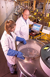 Harvey Blackburn and Ginny Schmit in front of a nitrogen tank