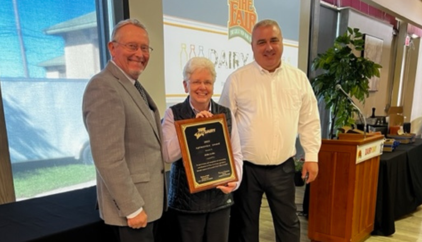 three people in an awards ceremony