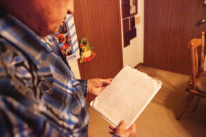 Trayton Greenfield looking at the legal pad he used to keep track of every Farm Bureau member he recruited. 