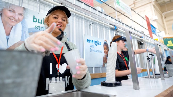Students serve up milk on the first day of the New York State Fair.