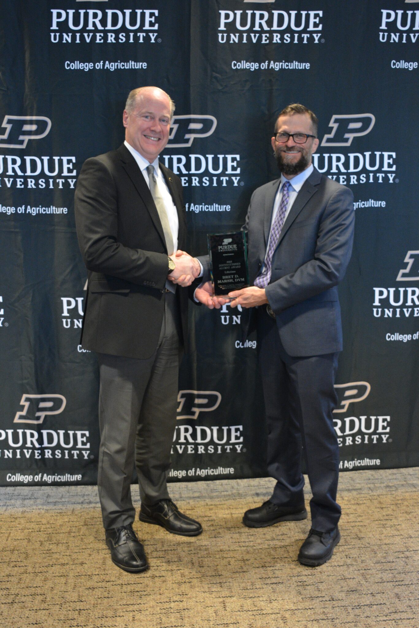 two men holding an award