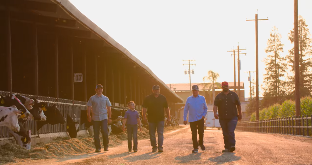 Above, third-generation dairy farmer Anthony Agueda (left) walks with his brother, father, grandfather, and uncle. The family has implemented a BioFiltro worm bed on their farm.
