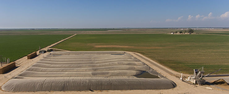 As solid separator (right) removes much of the manure solids before the stream enters covered-lagoon digester.  